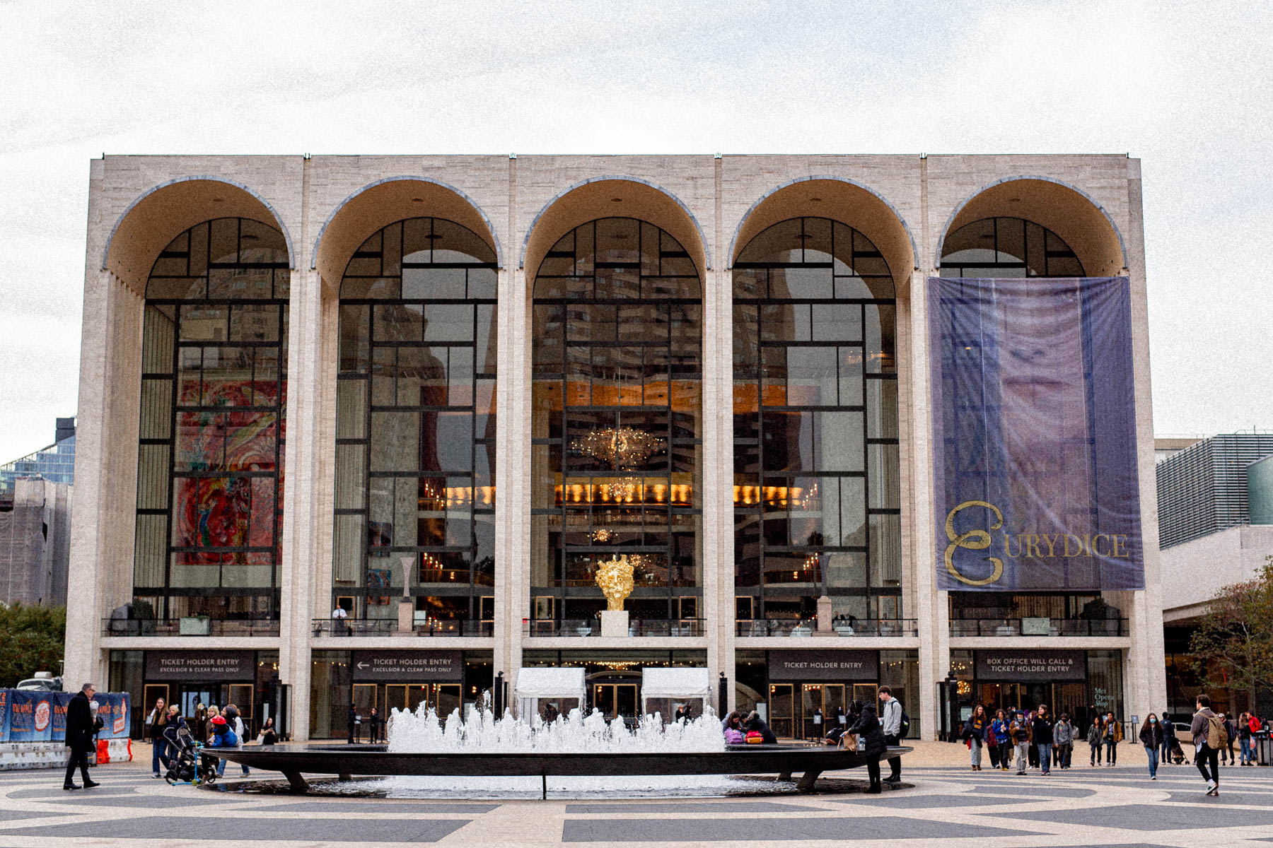The Metropolitan Opera House facade at Lincoln Center with its fountain and arched windows.