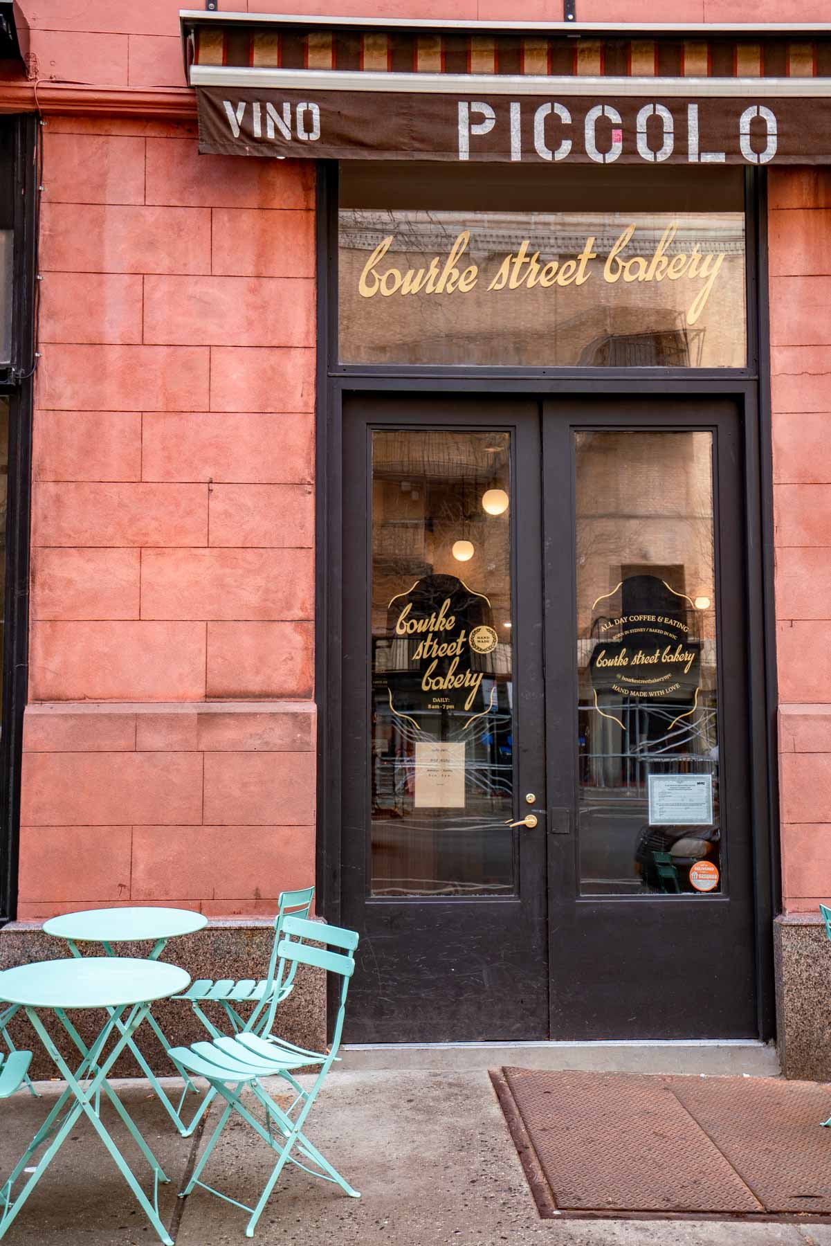 The storefront entrance of Bourke Street Bakery with outdoor seating on the sidewalk.