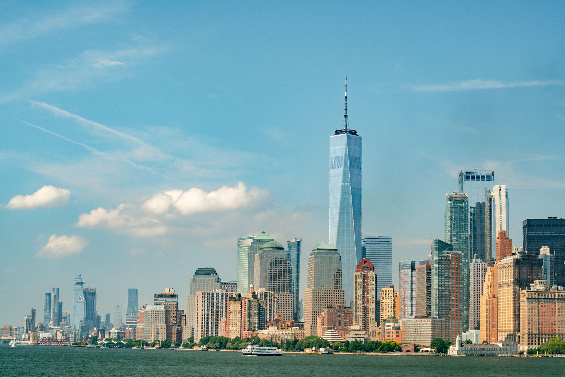 The Lower Manhattan skyline with One World Trade Center rises above the water.