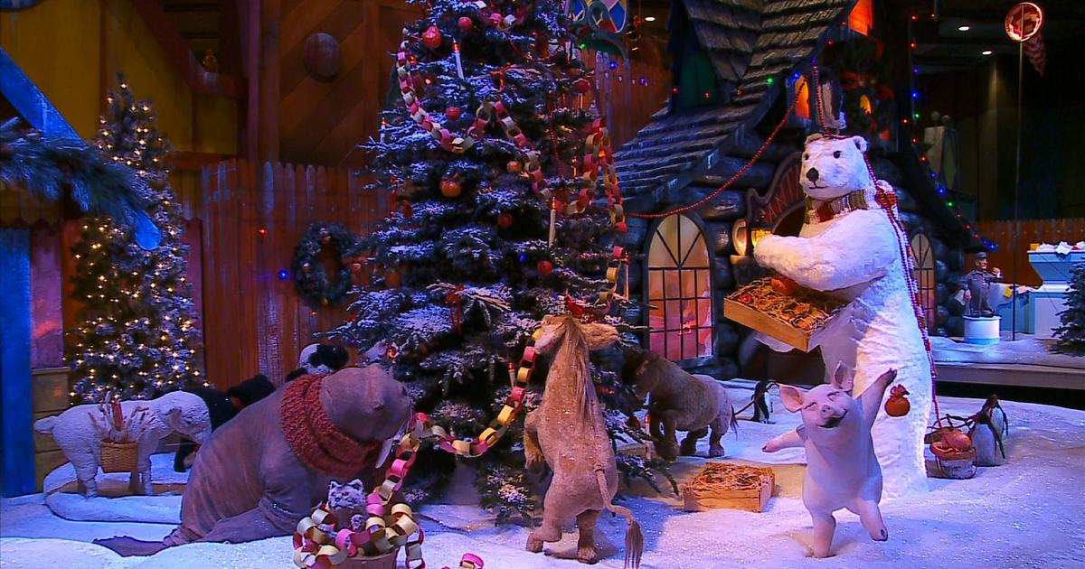 Animatronic animals decorate a Christmas tree inside Macy's Santaland display.