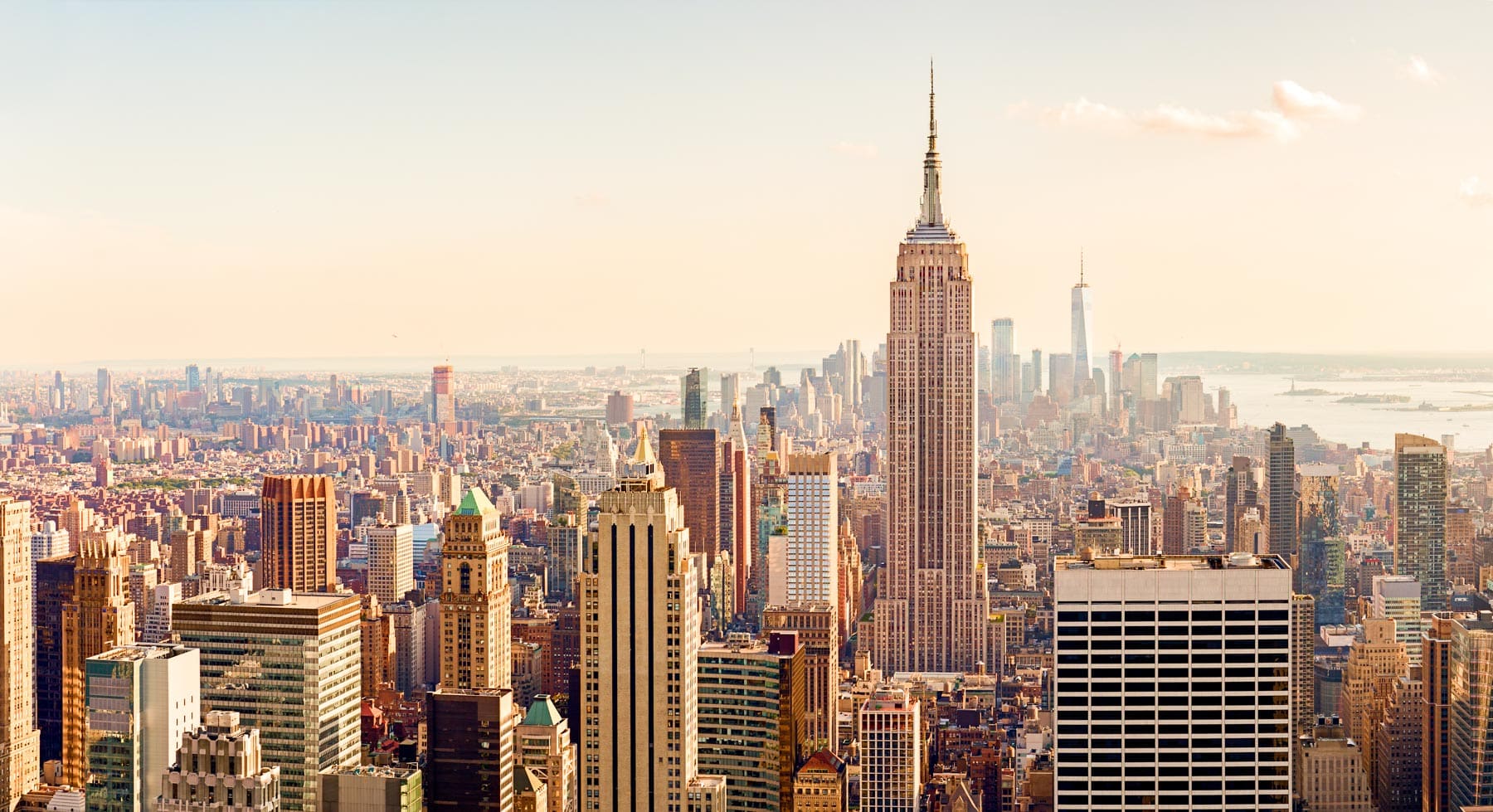 A view of the Manhattan skyline with the Empire State Building rising above surrounding buildings.