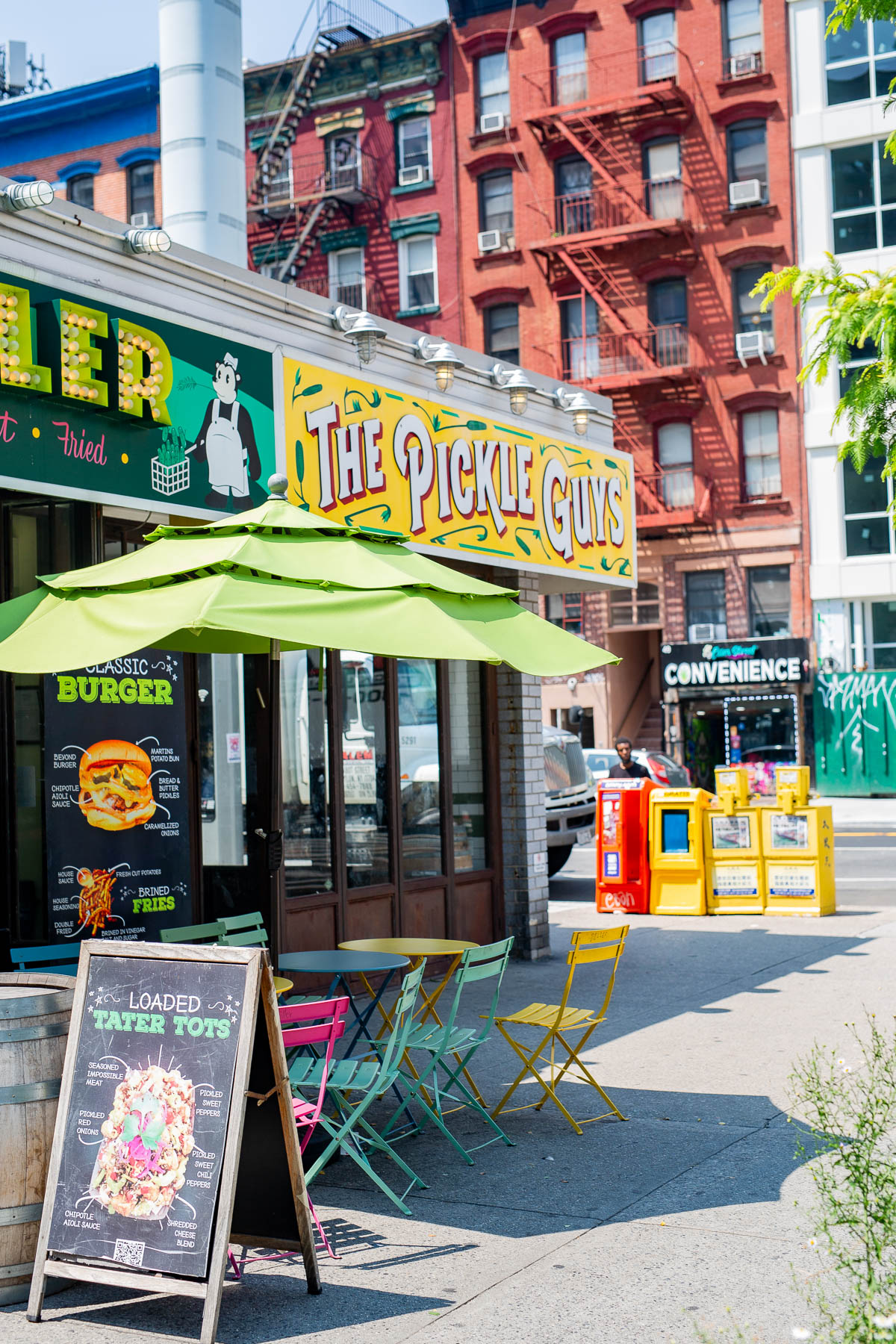 Storefront of The Pickle Guys with sidewalk seating on the Lower East Side.