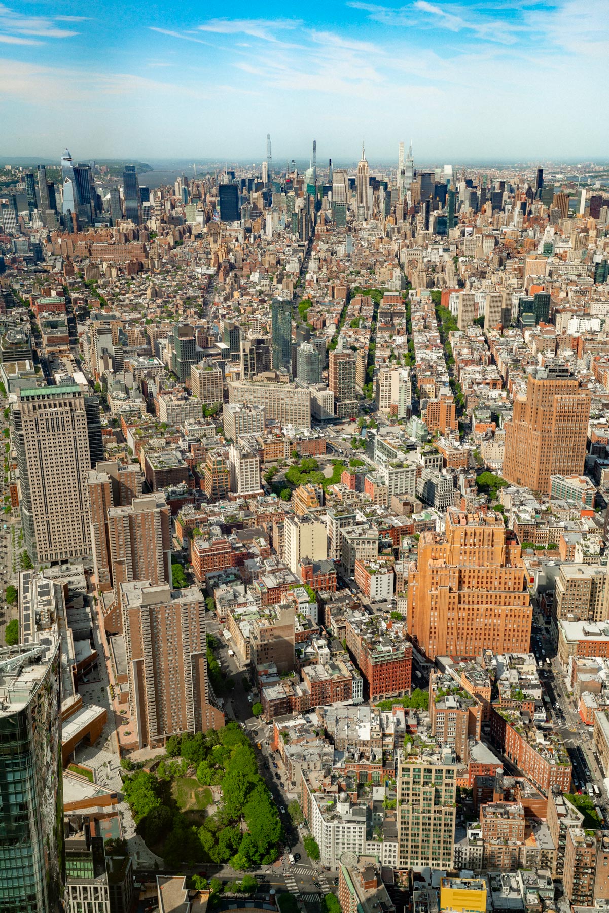 An aerial view of Manhattan's skyline stretching north from downtown, taken from One World Trade Center.