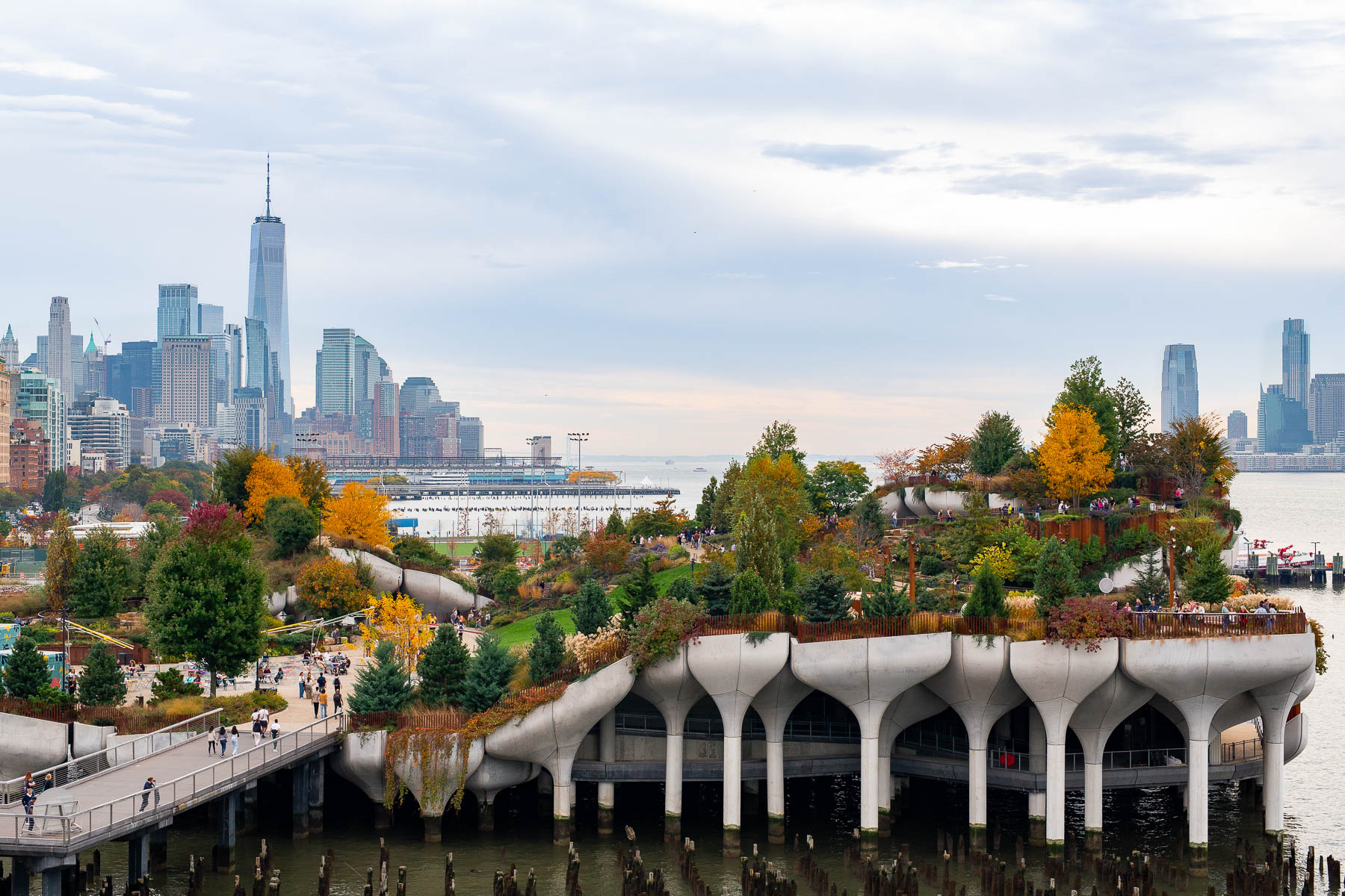 Little Island park juts into the Hudson River with the Lower Manhattan skyline behind it.