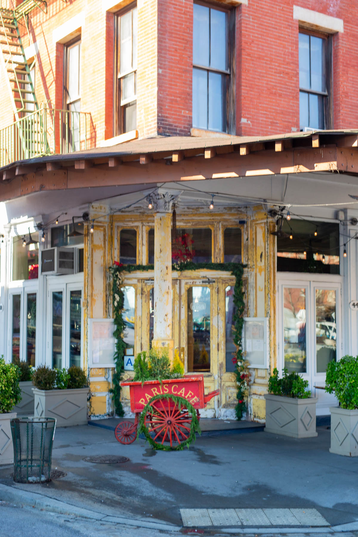 The historic storefront of Paris Cafe in the Financial District decorated with holiday garland.