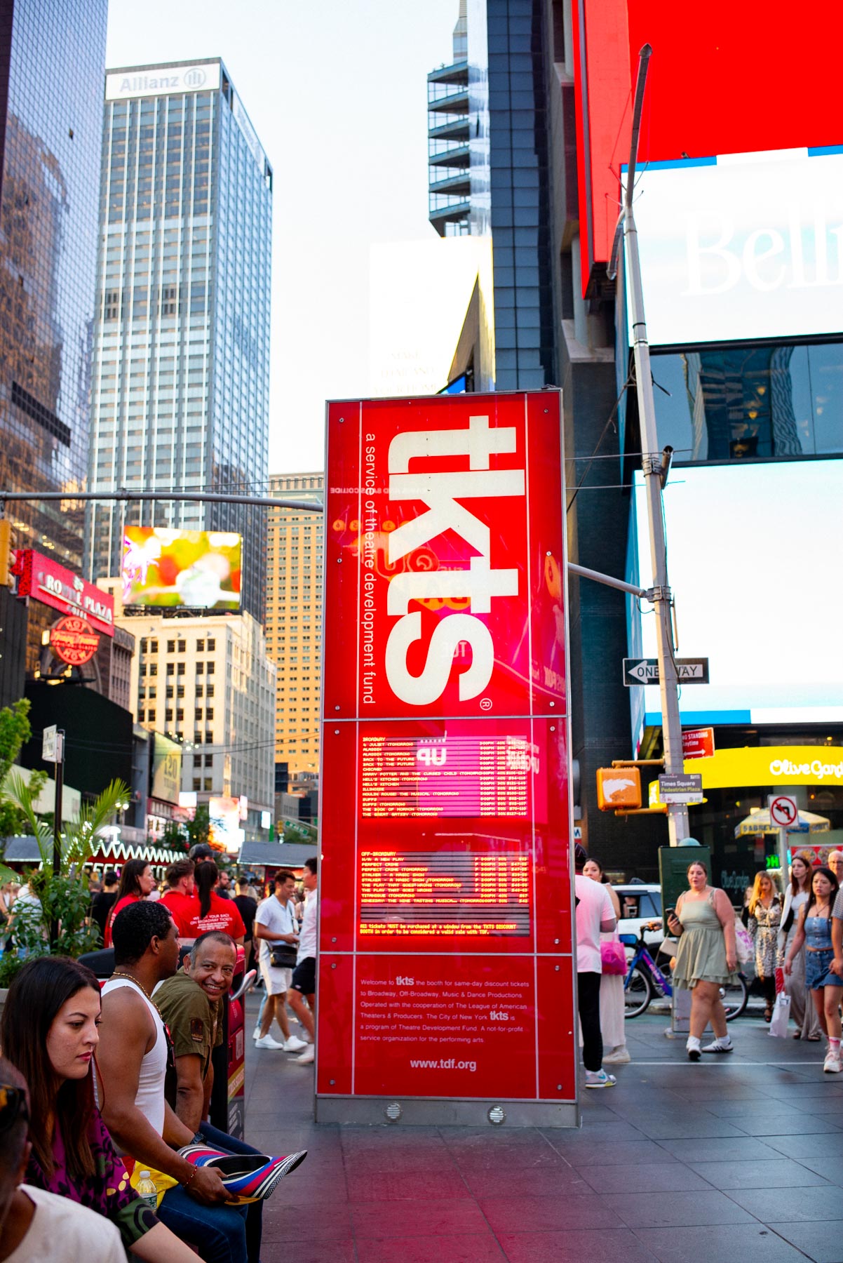 The red TKTS booth stands amid crowds in Times Square.