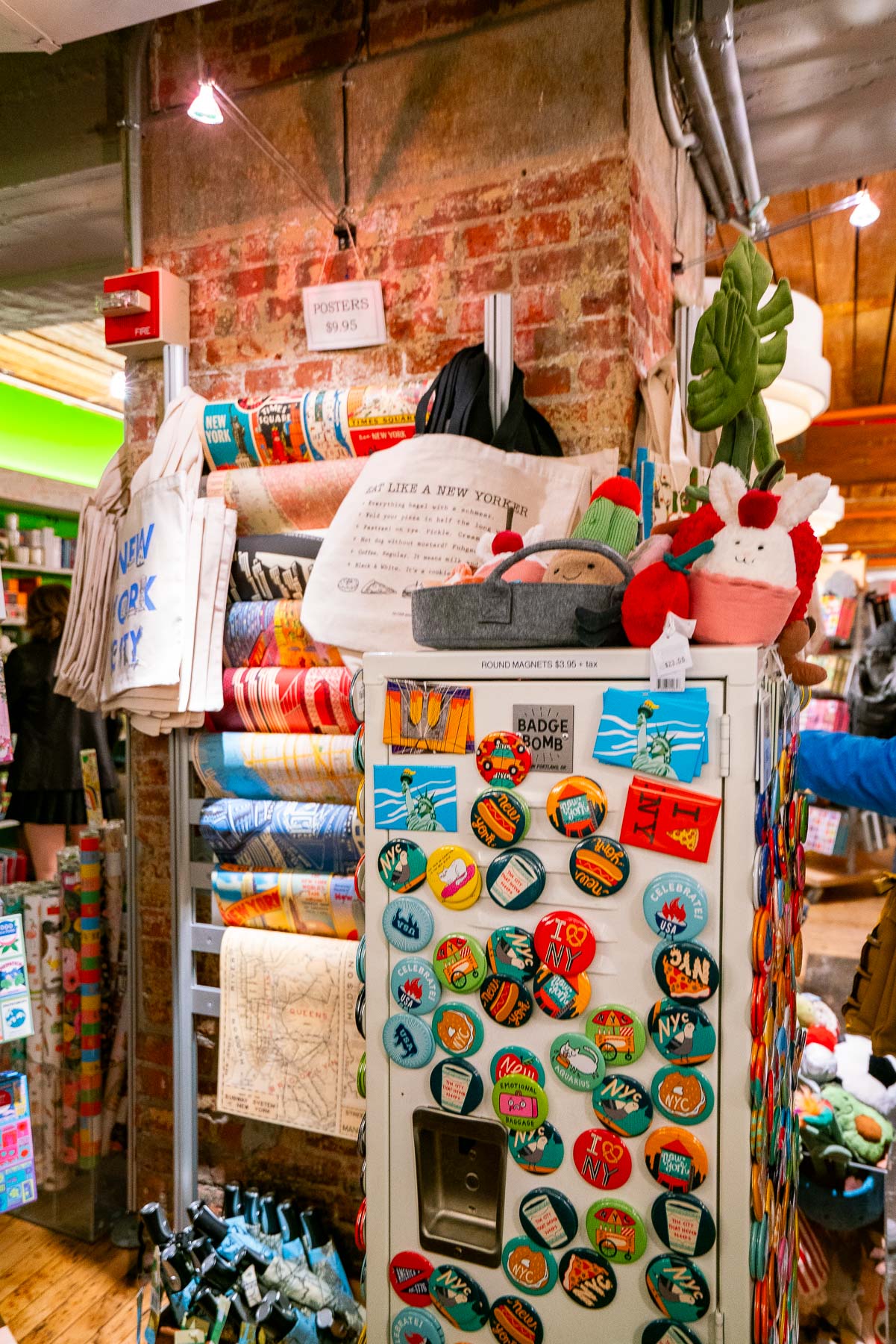 Souvenir rack at Posman Books with buttons, totes, and posters. One of the best stores at the Chelsea Market Souvenir rack at Posman Books with buttons, totes, and posters. One of the best stores at the Chelsea Market