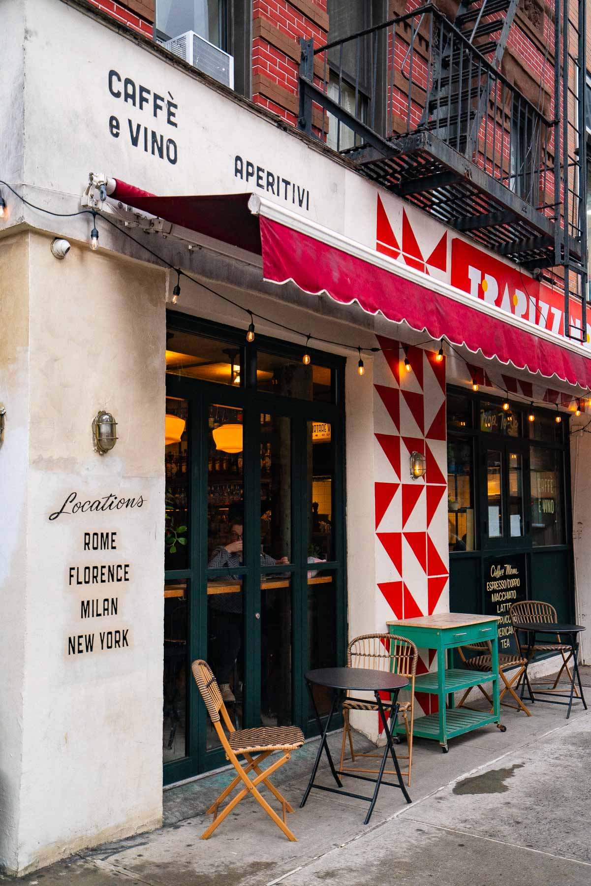 Storefront of Trapizzino restaurant on the Lower East Side with red awning and outdoor seating