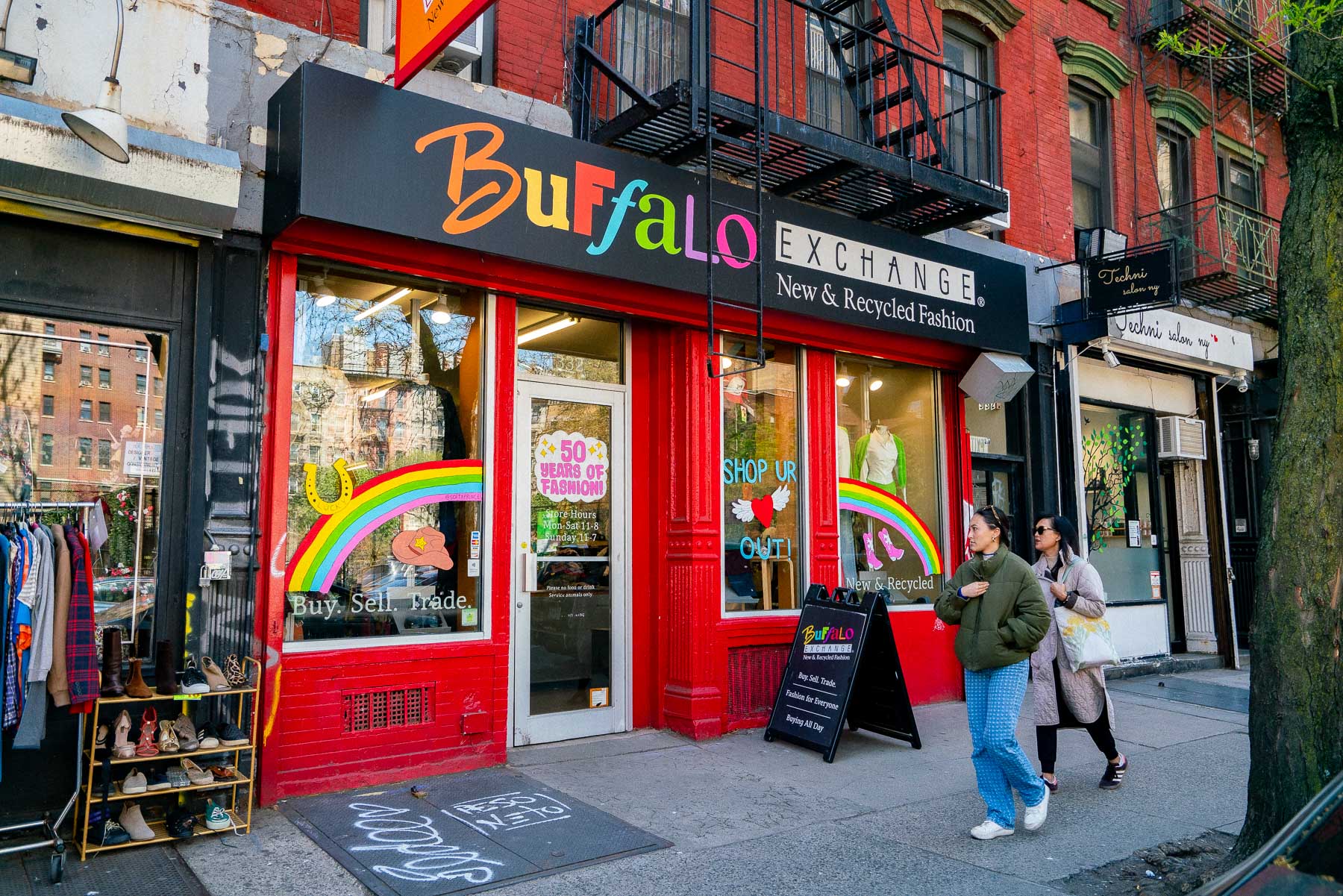 Two women walk past the Buffalo Exchange storefront in the East Village.