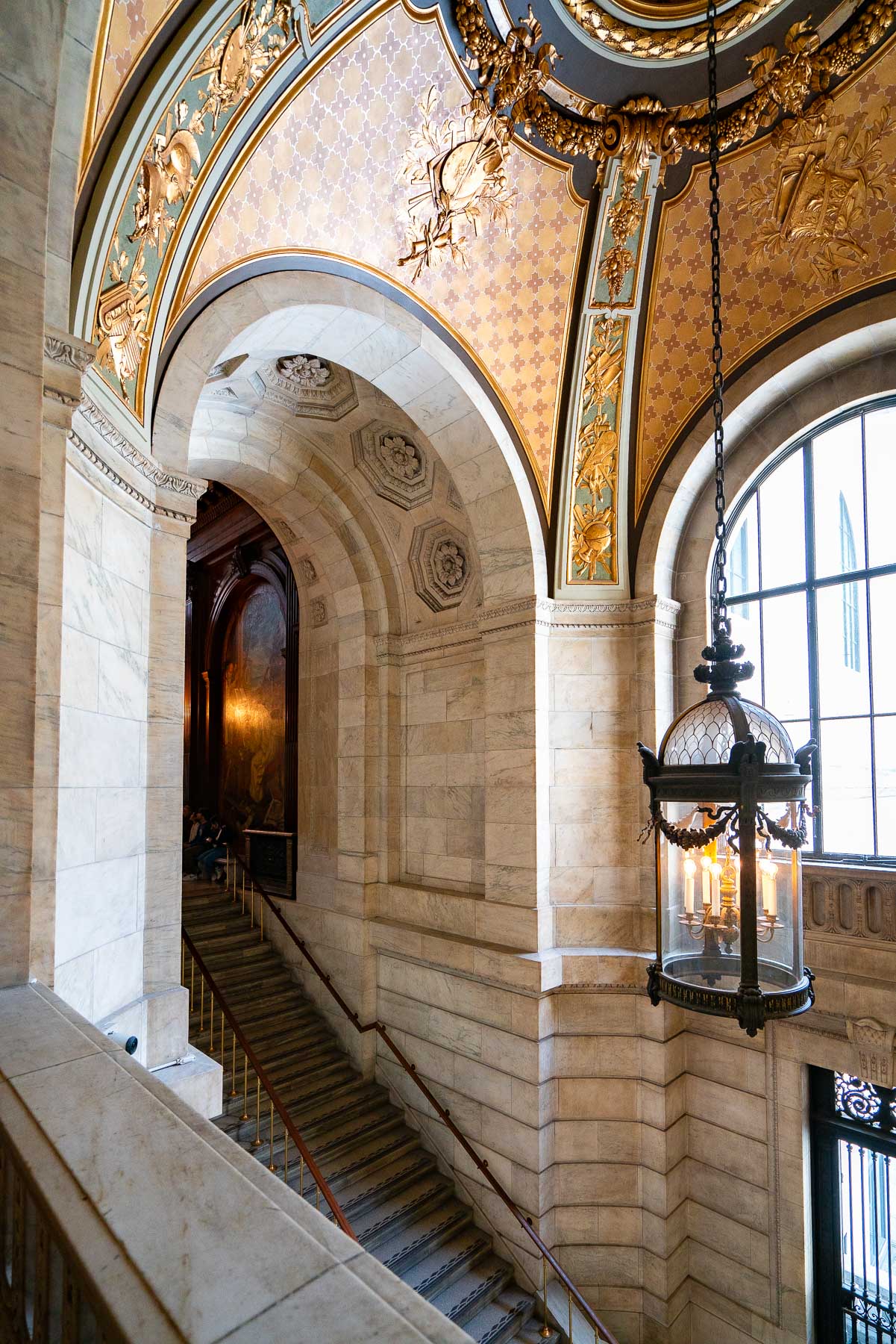 A gilded archway and staircase inside the New York Public Library's main branch.
