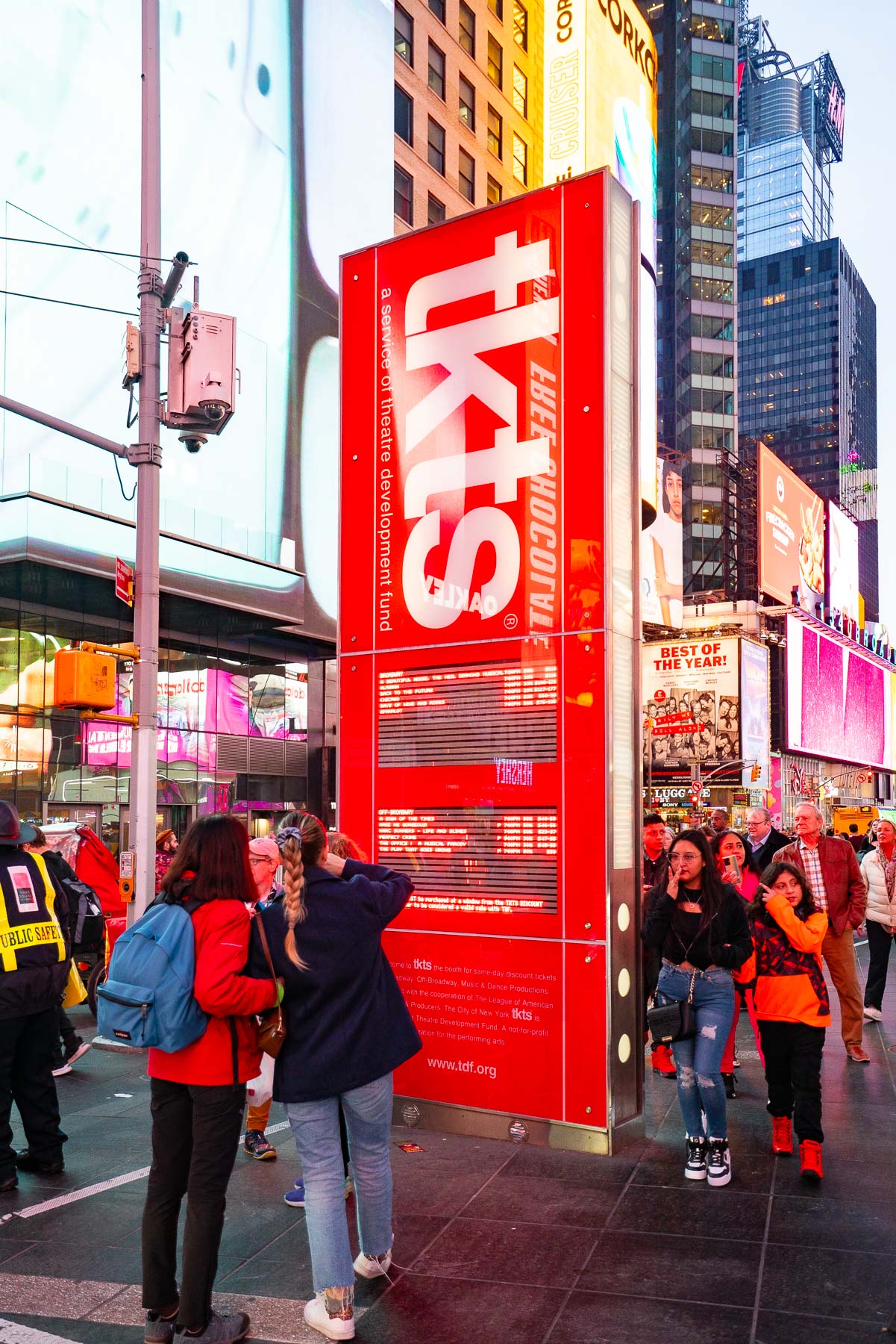 Tourists gather around the red TKTS ticket booth in Times Square.