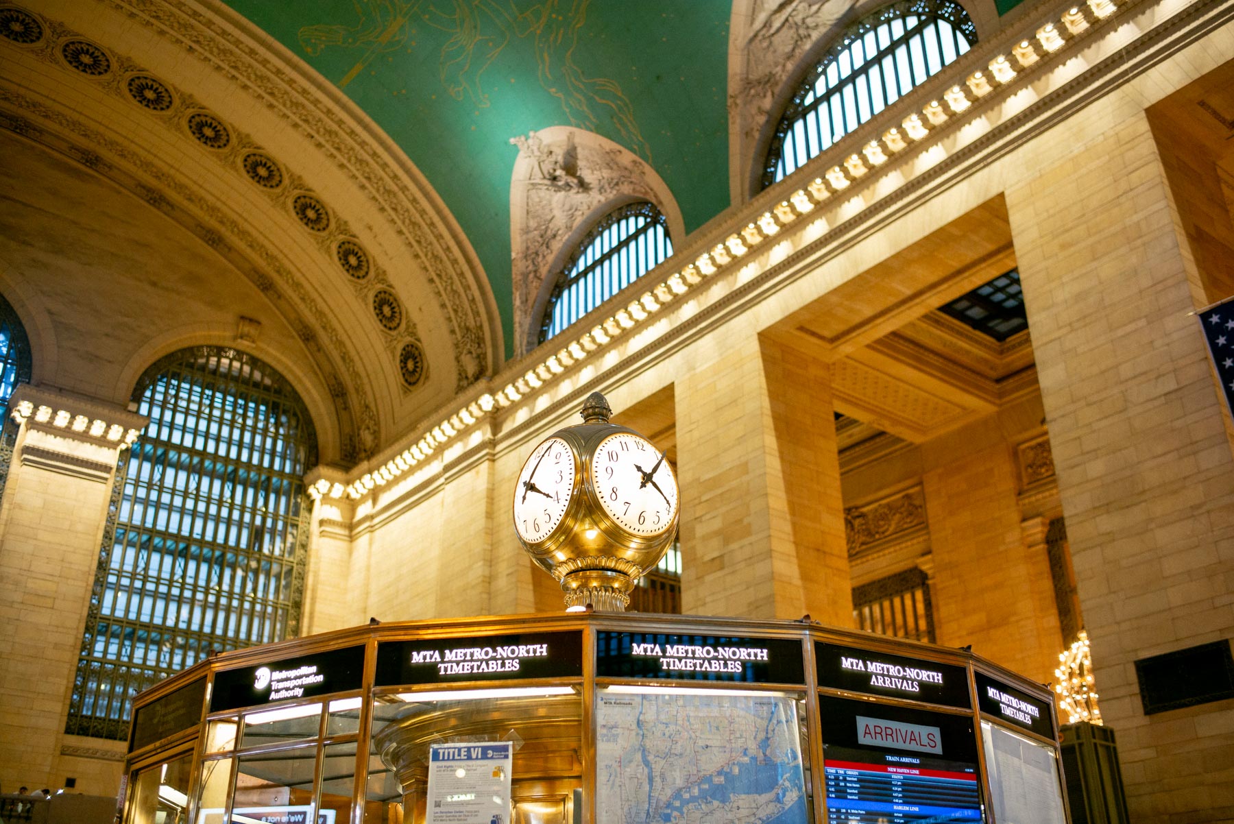 The iconic brass clock and information booth inside Grand Central Terminal's main concourse.