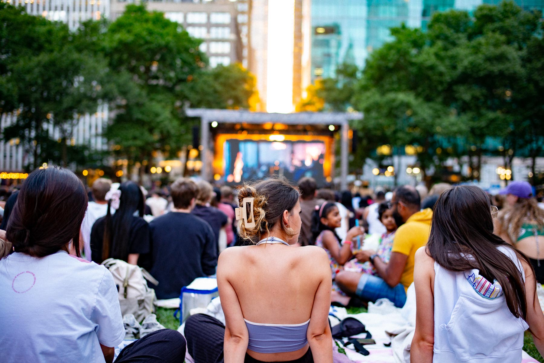 Group of girls watching a movie at Bryant Park in the summer