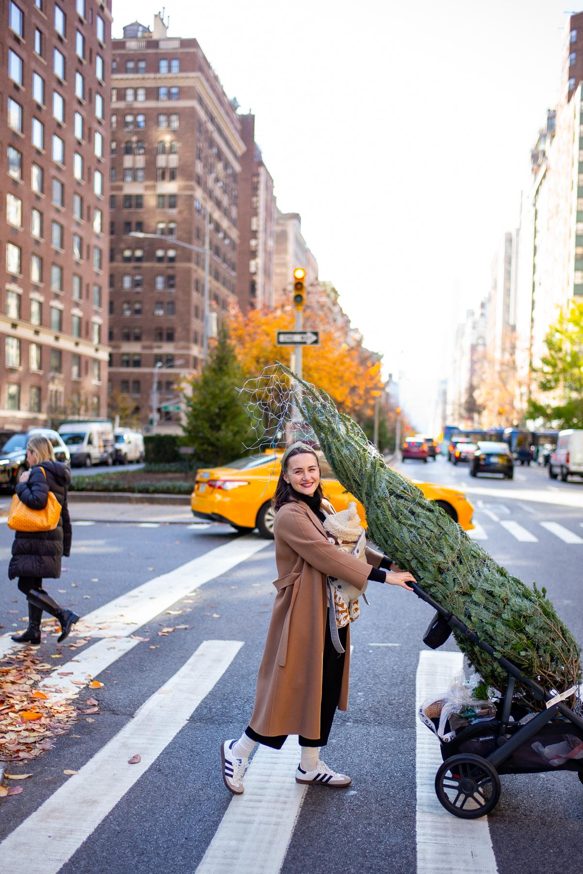 Mom pushing stroller in New York City taxi in the background