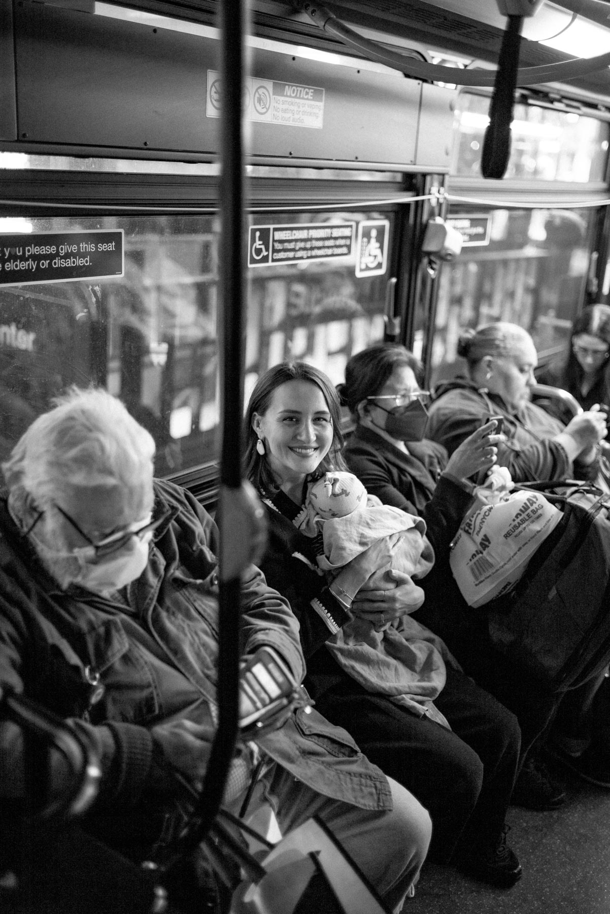 Baby riding a New York City bus with parent