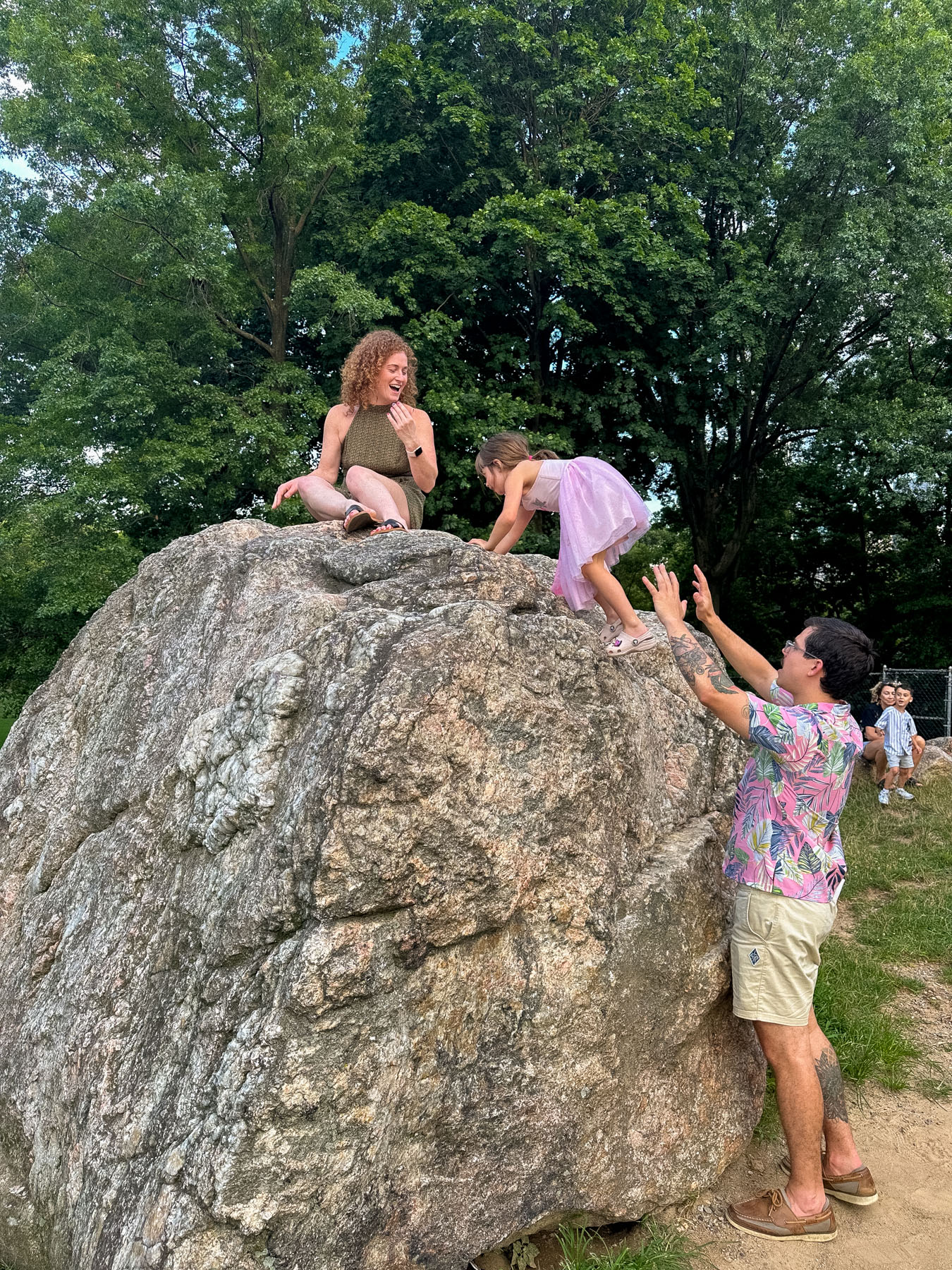Family climbing rocks in Central Park