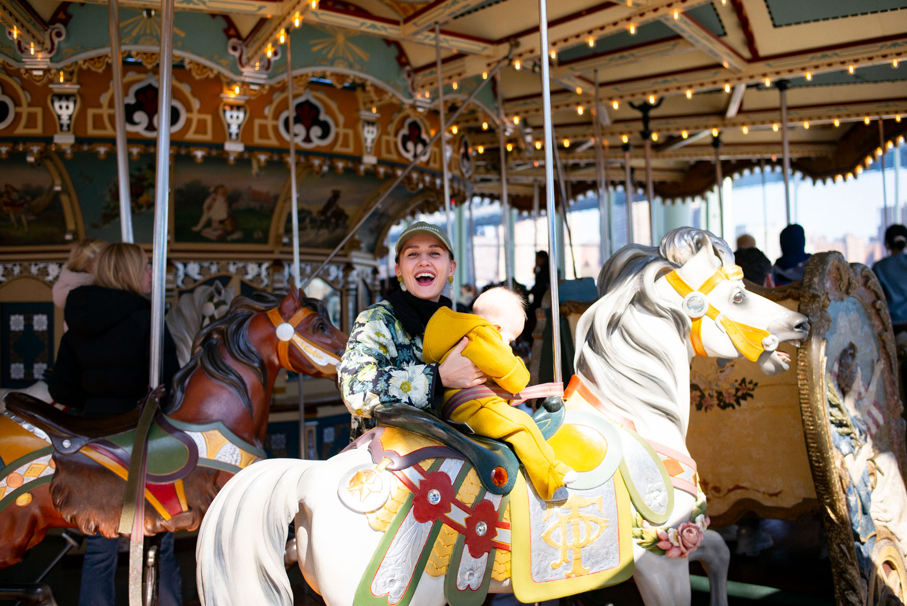 mom and baby on Jane's Carousel in DUMBO