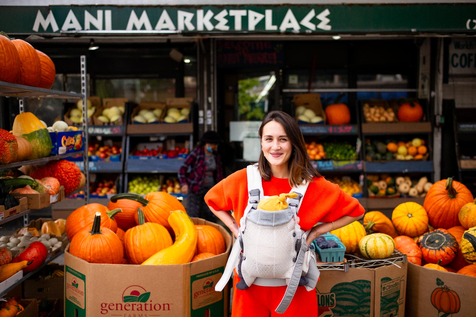 Woman using a BabyBjorn Harmony carrier while walking a baby in NYC