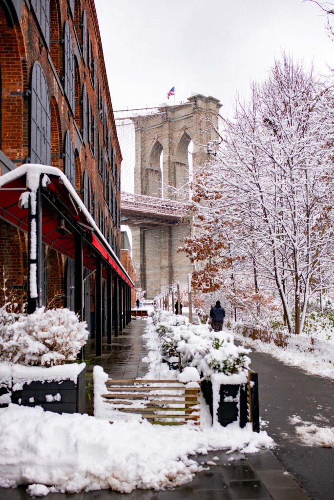 DUMBO Brooklyn covered in snow with the Manhattan Bridge in the background
