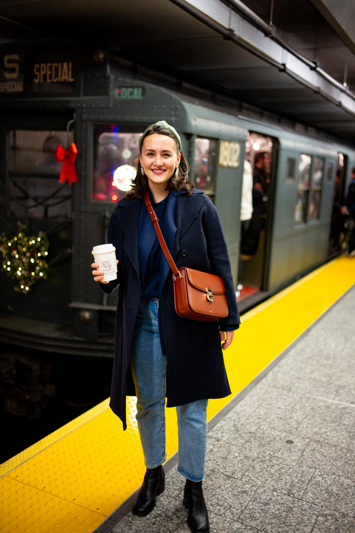 Passengers riding inside a New York City subway car during the holidays