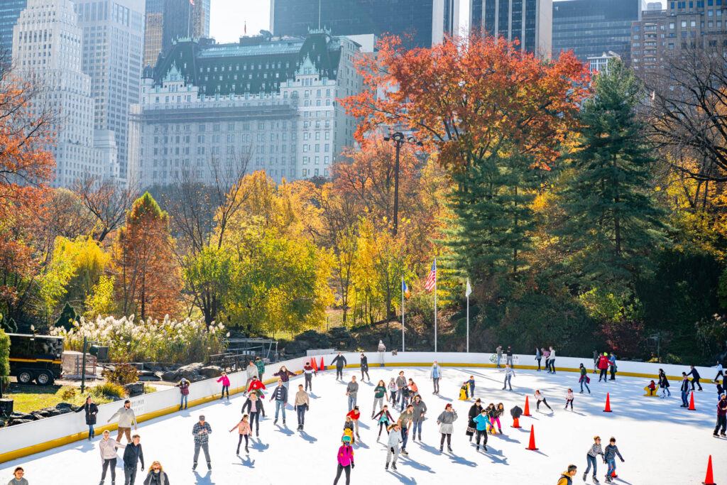 Ice skating at Wollman Rink in Central Park with the NYC skyline