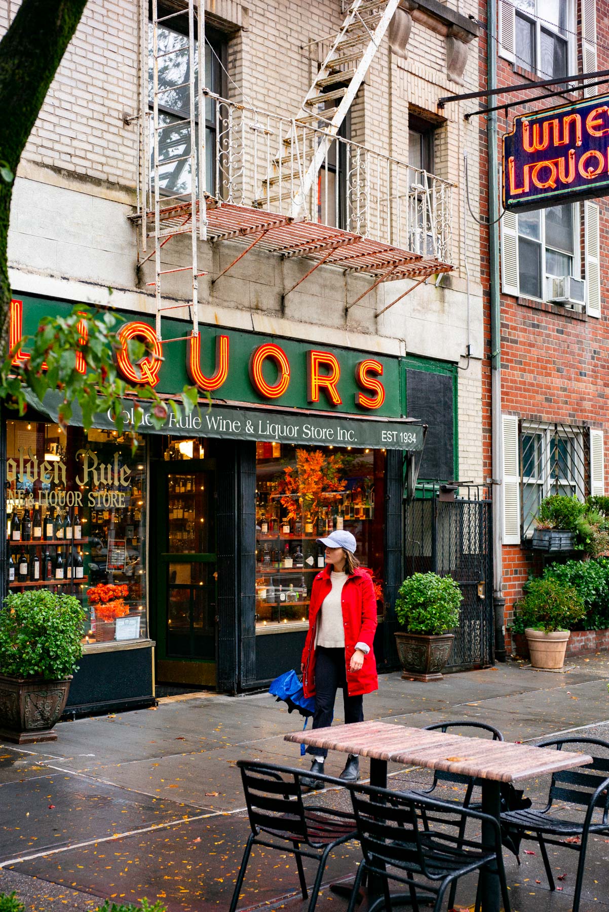 A quiet residential New York City neighborhood street with shops and apartment buildings